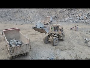 Caterpillar 966E Model Wheel Loader Works Like a Beast: Loading Big Rocks into Big Dump Trucks
