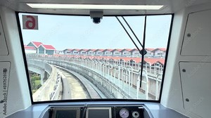 View from inside a modern train cockpit as it approaches a station. The control panel and front window highlight advanced technology and contemporary design. Stock Video