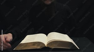 Christian pastor reading the Holy Bible. Hands turning pages