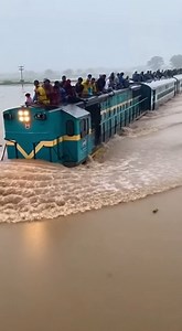 The Train Moves Slowly Through a Vast, Waterlogged Plain with Passengers on Top for Safety. | Alone Story