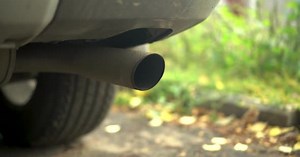 Car Exhaust Pipe Closeup White Smoke From a Car Chimney
