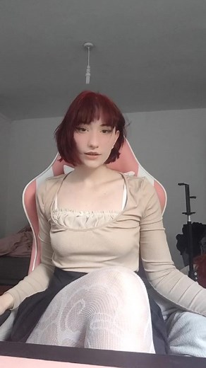 Adjusting Hair in a Cozy Gaming Setup