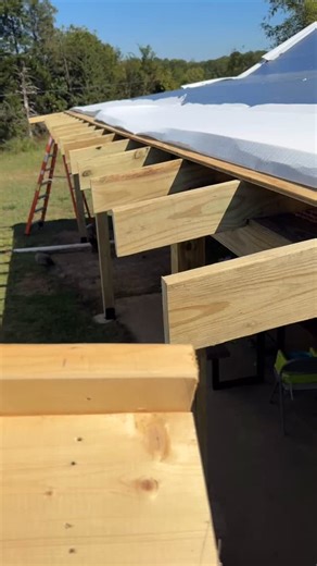 Simple easy jig to mark rafters tails to cut them off. Saves pulling out a speed square every time. Just snap your chalk line on top and then make this out of a few scraps of wood. #jig #raftertails #rafterjig #raftercutting #porchrafters | Smart Easy DIY