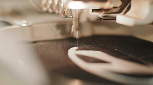 The automatic embroidery machine is working at high speed. Close-up 12