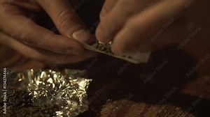 Man rolling weed for recreational use, marijuana legalization, video sequence