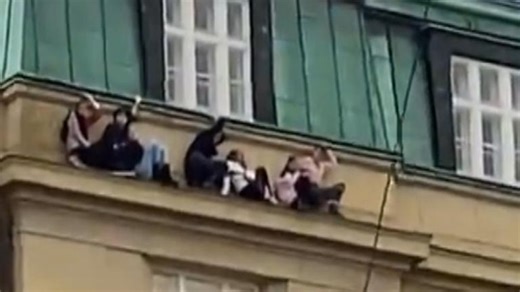 Footage circulating on social media shows people hiding on a building ledge amid a mass shooting in Prague.