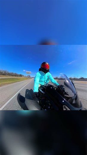 Motorcyclist Rides Through Urban Highway