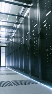 Camera Walk-Through Shot of a Working Data Center With Rows of Rack Servers. Information Technology, Data Storage and Artificial Intelligence Concept. Online Internet Data Service Room