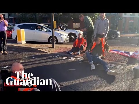 Motorists and paramedic crew drag away Insulate Britain protesters on Wandsworth Bridge