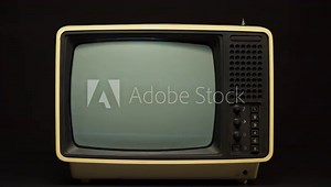 Man turning on old retro television on black background, searching for a signal, channel setting. Broken old-fashioned TV with noise screen on table, bad signal reception, cinematography concept. Stock Video