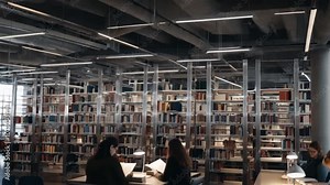 A modern library featuring industrial elements, such as metal shelving and exposed lighting, for a contemporary reading space.