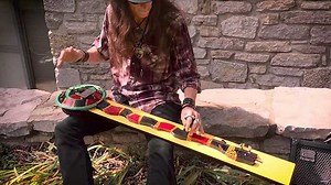 Justin Johnson plays a song on a 2-string diddley bow