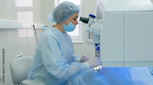 Eye surgery process. The surgeon looks through an ophthalmic microscope. Laser eye correction using SMILE method.