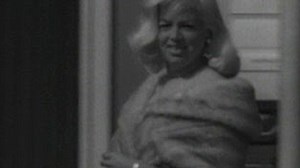Archive: Actress Diana Dors walks through airport