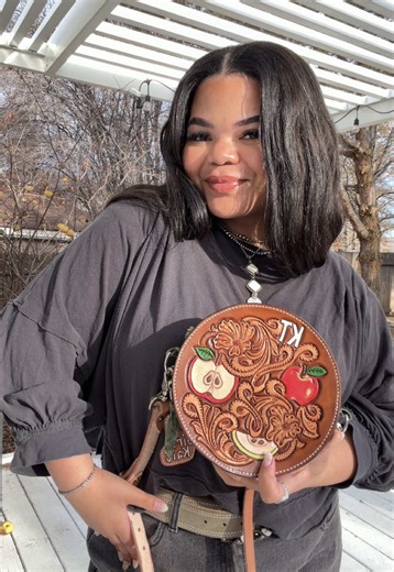 Who says apples and leather can't be a thing? 🍎 So grateful I crossed paths with @Kait Thornton on Instagram! Something about her just felt right. Maybe it's that we're both from Washington or maybe it's the sweetest vibes ever... either way, this bag was meant for her!🤍 Wearing some of my fav jewelry from Nevada silversmithing and @A Bar Silver Co. and my amazing buckle is from my girl @The Silver J #TooledLeatherBag #LeatherBag #westernoutfits
