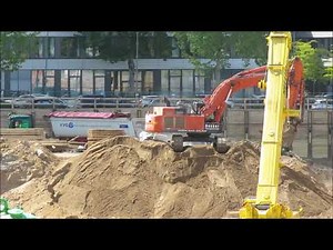 Excavator Hitachi 470 load truck - huge construction site