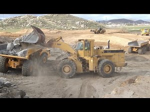 CAT 988F Loader loading Volvo A45G articulated trucks- D10T dozer feeding pile