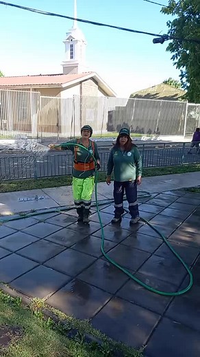Garden Hose Watering Techniques on a Wet Pavement