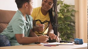 Siblings drawing together at home