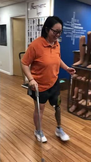 Sarah, an above-the-knee amputee walking post-surgery
