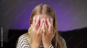 Cheerful Young Woman Play With Pink Sticky Notes With Eyes Drawn on Them, Covering Face, Laughing and Shaking Head