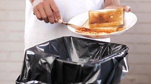 throwing eaten food in a garbage bin