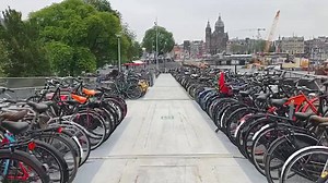 3.4K views · 122 reactions | ‪The “fietsflat” was first built in 2003, as a temporary means to store bicycles while Amsterdam Central Station was undergoing renovations.‬ ‪Now, this permanent 100-metre-long floating structure holds 2,500 bikes, and is the single most photographed attraction in the entire city.‬ | Dutch Cycling Embassy | Facebook