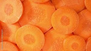 Macro video of a carrot slice using a probe lens. The lens also captures the subtle differences in density, resulting in varying shades of orange that add depth and visual interest to the image.