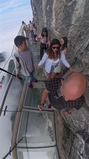 Glass walkway under a cliff in China, would you dare? #china #zhangjiajie #travel