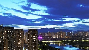 Time lapse of modern apartments in the city at night