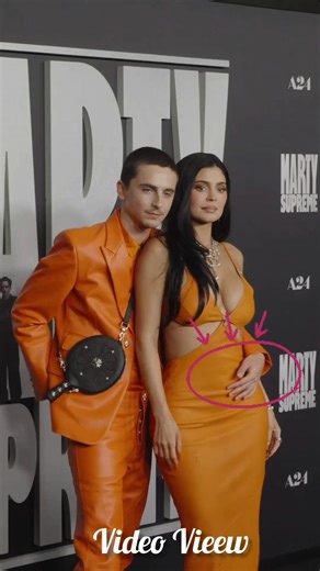 Timothée Chalamet and Kylie Jenner share a cozy embrace, matching in style at the red carpet event