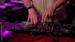 DJ using controller console to mix music list in club close up . Caucasian deejay person touch control panel for change audio on disco party indoors. Slow motion 4K video with movement Stock Video