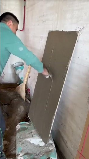 the process of installing brown patterned ceramic tiles on the floor in a building room #popular