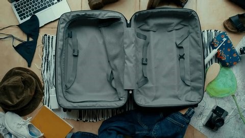 clip-3975076111-person-packs-suitcase-teenager’s-room-throwing-clothes