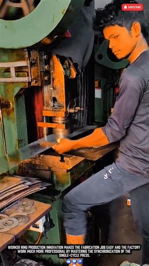 Worker shaping steel rings with a stamping press machine for symmetrical production results