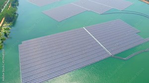 Flying over a solar panels floating on water. It installing solar panels on floating platforms or structures that are placed on bodies of water such as lakes, reservoirs, and even the ocean. 4K Stock Video