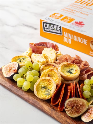 Take your charcuterie board to the next level. ✨ Our Mini Quiche heat up in just one minute in the microwave and add a warm, flaky touch to your spread. They're the perfect, easy-to-make complement to your cheeses and cured meats. -- Donnez une nouvelle dimension à votre plateau de charcuterie. ✨ Nos mini quiches se réchauffent en seulement une minute au micro-ondes, et ajoutez une touche chaude et feuilletée à votre festin. Elles sont le parfait ajout simple pour agrémenter vos fromages et char