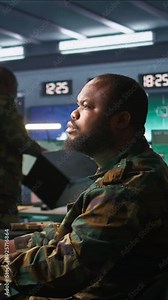 Vertical video Officer in command center helped by colleague to plan, analyze and gather information on enemy troops. Team of agents in base of operations doing assessment of adversaries Stock Video