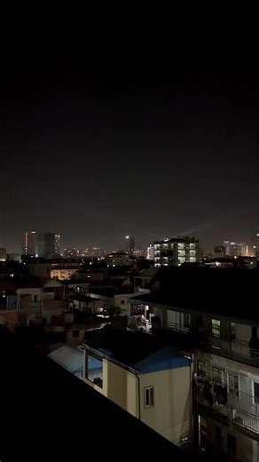 Watching the night scenery from a high-rise building.