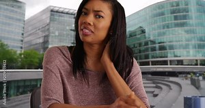 POV shot of black business woman video calling doctor about neck pain while on business trip in London, View from computer screen of woman with medical problem web chatting outside, 4k Stock Video