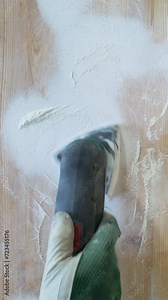 Grinding the surface of an old table with a grinding machine. Furniture renovation, DIY repair, repair by oneself and home improvement