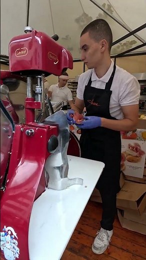 Slicing Italian Prosciutto Ham. Traditional Machine. Bra CHEESE Festival