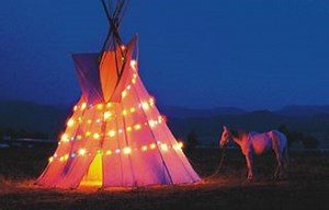 There's a funny fat man in a silly red suit Stuck in the smokehole of our tipi. "Ho, Ho, Ho!" - He thinks he's talking Indian "No, No, No!" - Aint no way we'll let him in Not no funny fat man in a silly red suit Stuck in the smokehole of our tipi. Grandma's skinning his deer And Grandpa's cooking up the meat From the funny fat man in the silly red suit Stuck in the smokehole of our tipi. ( Chorus ) Aunty's taking his boots And Uncle's stripping down the sled From the funny fat man in the silly r