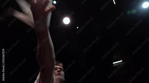 Close up of Muscular white circus artist on the aerial straps on black background in slowmotion. Movement and motion concept