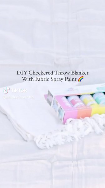 How cute is this checkered blanket? 😍 It’s so easy to create colorful patterns with Tulip Fabric Spray Paint! ✨ #fabricspray #fabricspraypaint #diyhomedecor #upcycleddecor #throwblankets #diydecor