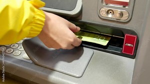 Woman withdrawing money at ATM machine with 4k resolution