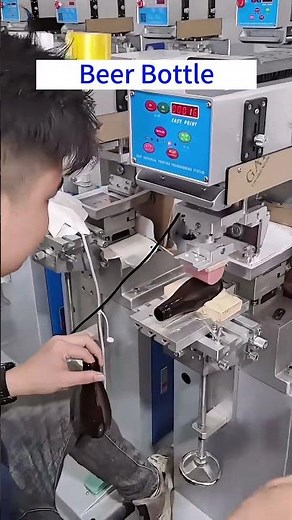 Print on the beer bottles with half-automatic pad printing machine.