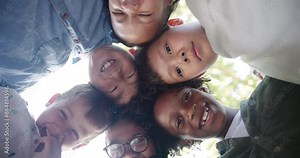 Children, face and friends with huddle in outdoor park for support, bonding or development. Low angle, diversity and young kids with solidarity for community, happiness or connection in playground