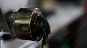 Traditional italian homemade pasta being made on machine for cutting dough. Fresh spaghetti pasta coming out from pasta machine, close-up. Chef uses pasta cutting machine, black spaghetti, cuttlefish