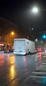 Delivery Truck Swallowed by Sudden Sinkhole at Rain-Soaked Intersection 🚚 Urban City Center — Night 2025 Street-level surveillance footage captures a busy intersection during a heavy rainstorm when the asphalt beneath a parked delivery truck suddenly begins to sag. Within seconds, the road surface cracks and collapses, sending the rear of the truck sliding backward into a dark, muddy sinkhole as streetlights flicker and sparks flash nearby. The sound of cracking pavement and a deep rumble echoe